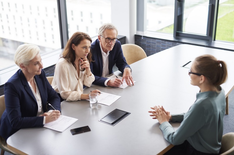 A group of people sitting around a tableDescription automatically generated